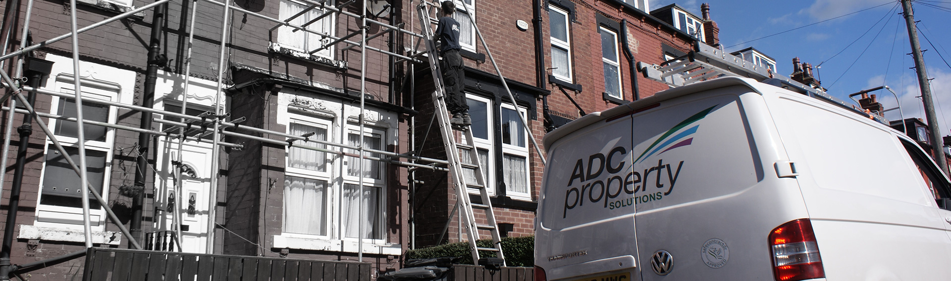ADC construction works with scaffolding and a branded company van