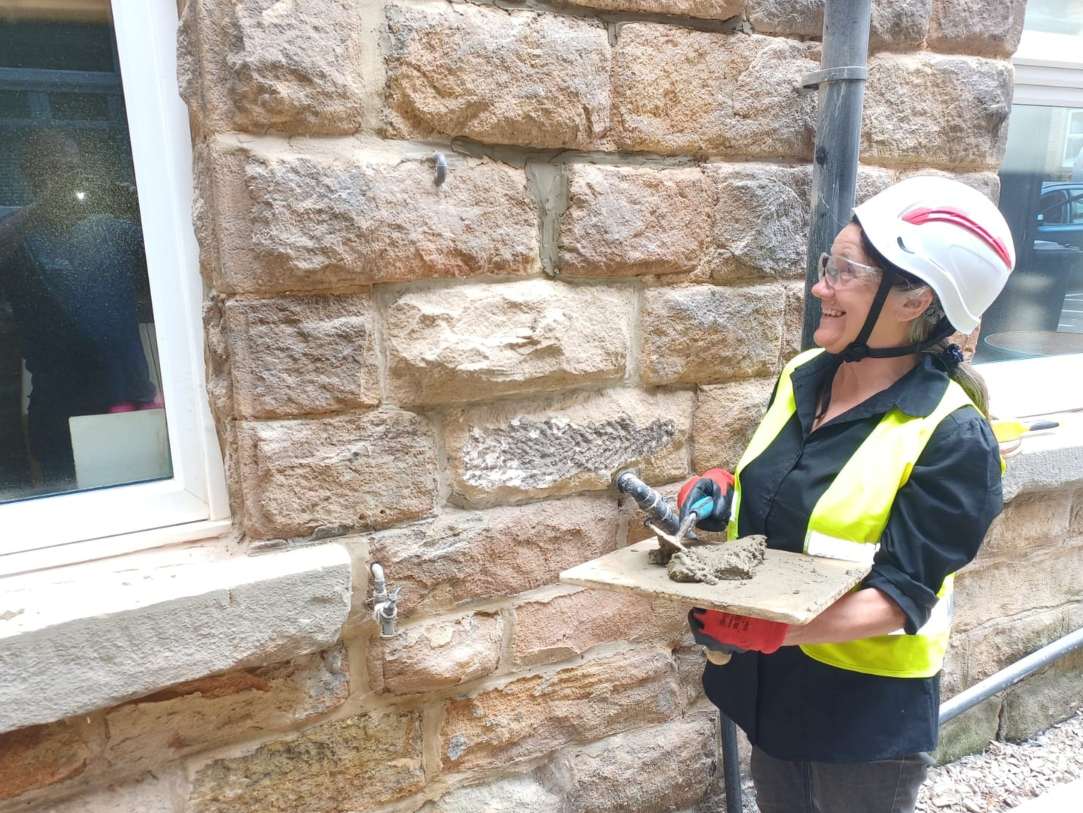 A learner gaining practical experience of brickwork on a West Yorkshire property